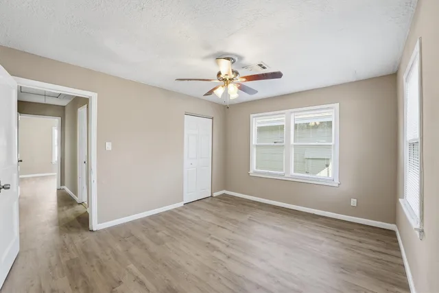 a view of an empty room with a fan