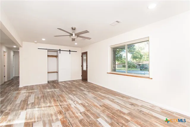 a view of an empty room with a window