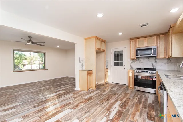 a kitchen with stove cabinets and refrigerator