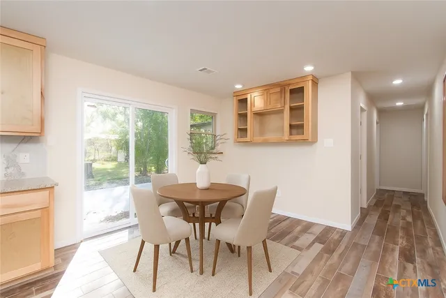 a view of a dining room with furniture and wooden floor