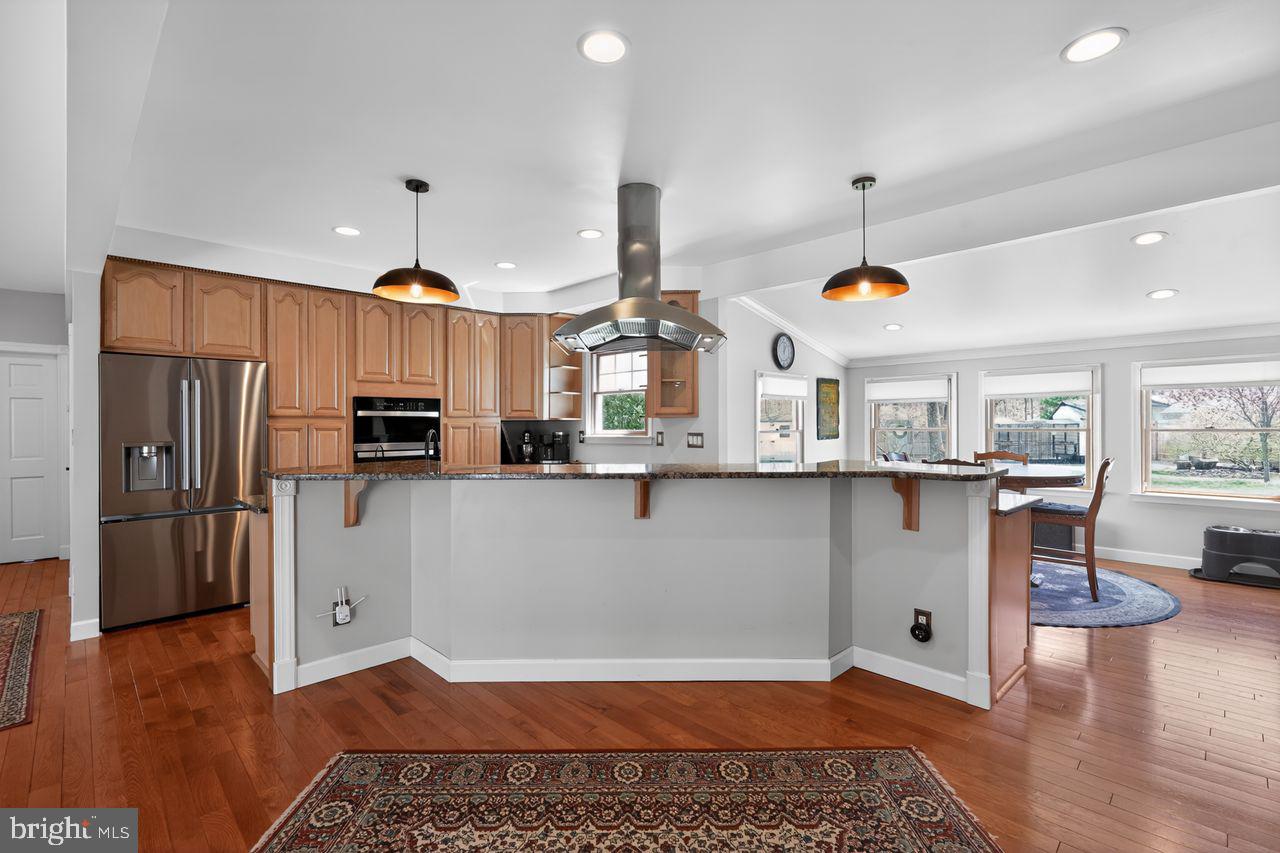 21 Mill Road Shamong, NJ 08088 - Photo 13 of 52 a kitchen with stainless steel appliances granite countertop a refrigerator a stove and a wooden floors