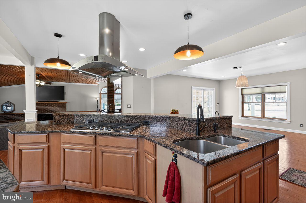 21 Mill Road Shamong, NJ 08088 - Photo 14 of 52 a kitchen with stainless steel appliances granite countertop a sink a stove and a wooden floors
