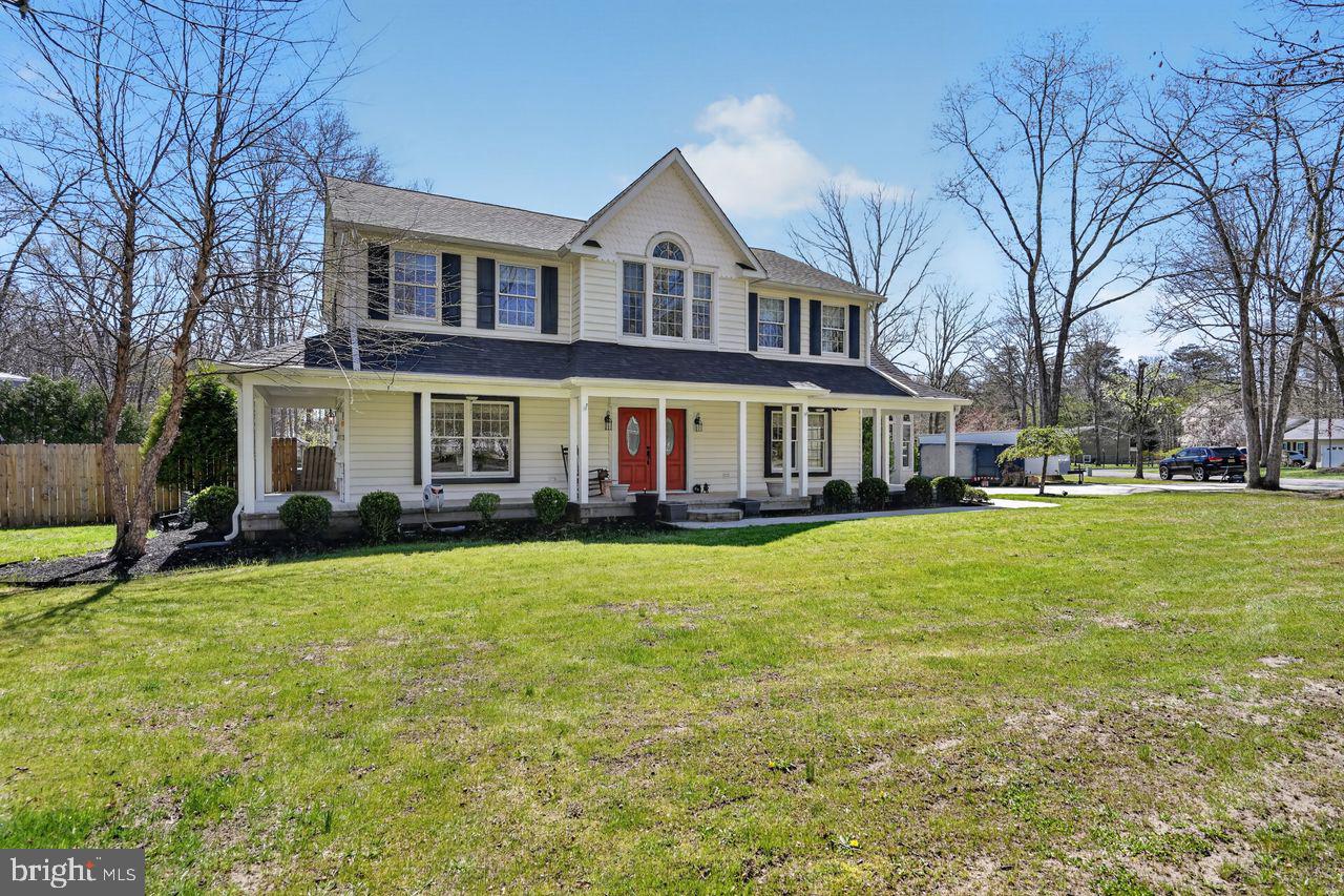 21 Mill Road Shamong, NJ 08088 - Photo 2 of 52 a view of a yard in front of a brick house with many windows