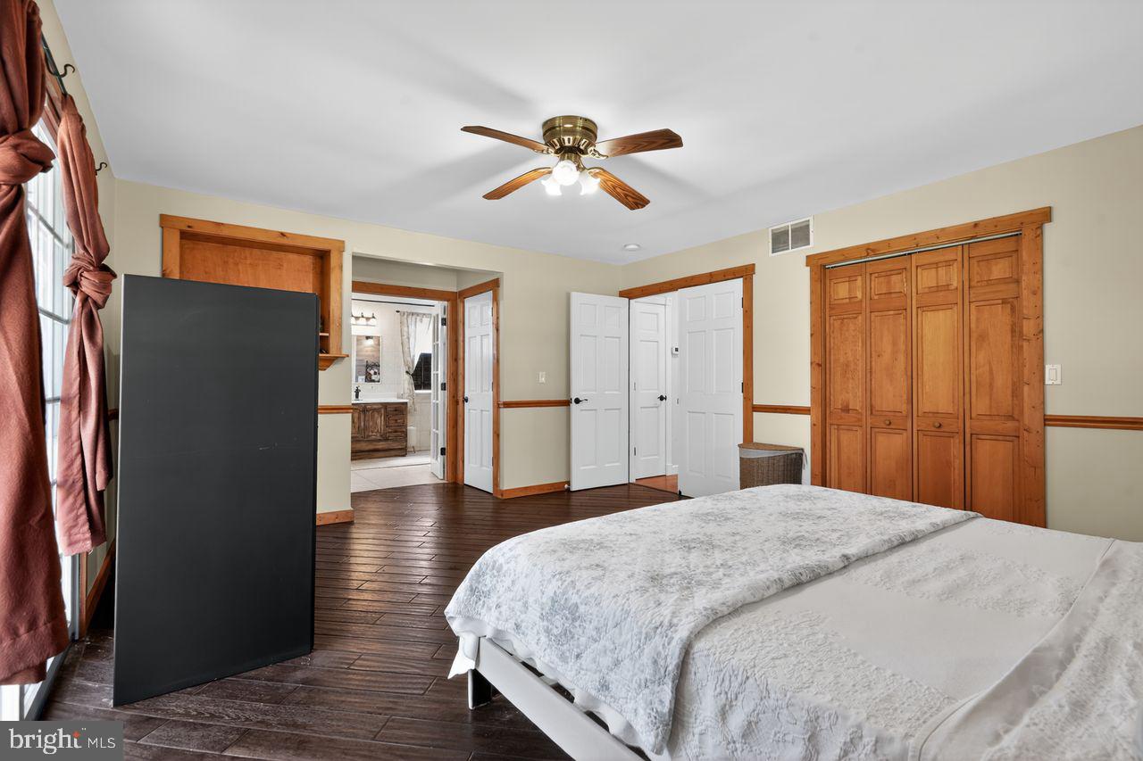 21 Mill Road Shamong, NJ 08088 - Photo 28 of 52 a bedroom with a bed and wooden floor