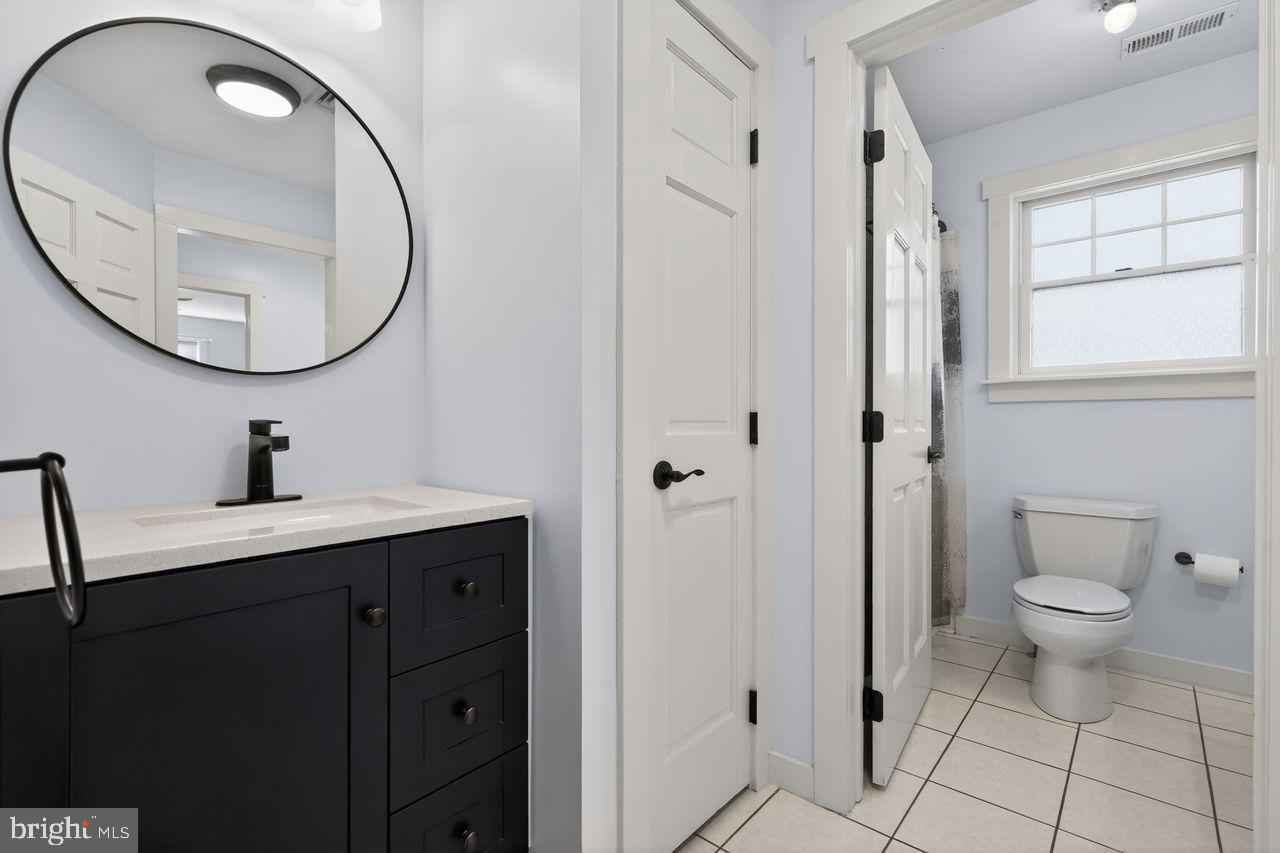 21 Mill Road Shamong, NJ 08088 - Photo 36 of 52 a bathroom with a toilet a sink a mirror and a window