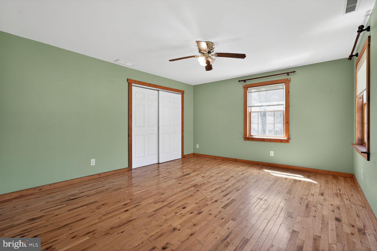 21 Mill Road Shamong, NJ 08088 - Photo 40 of 52 a view of empty room with wooden floor and fan