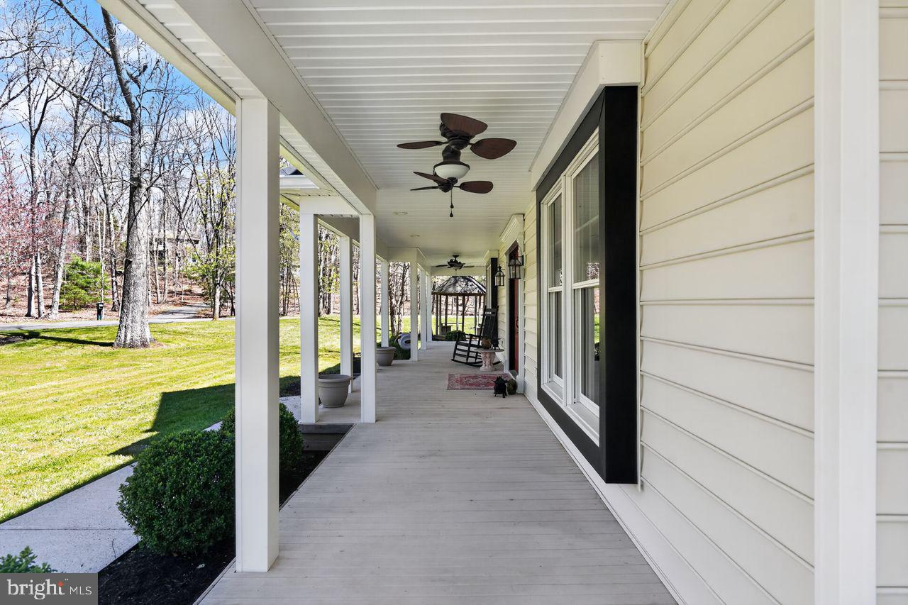 21 Mill Road Shamong, NJ 08088 - Photo 7 of 52 a view of a porch with wooden floor and stairs