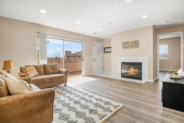 a living room with furniture and a fireplace
