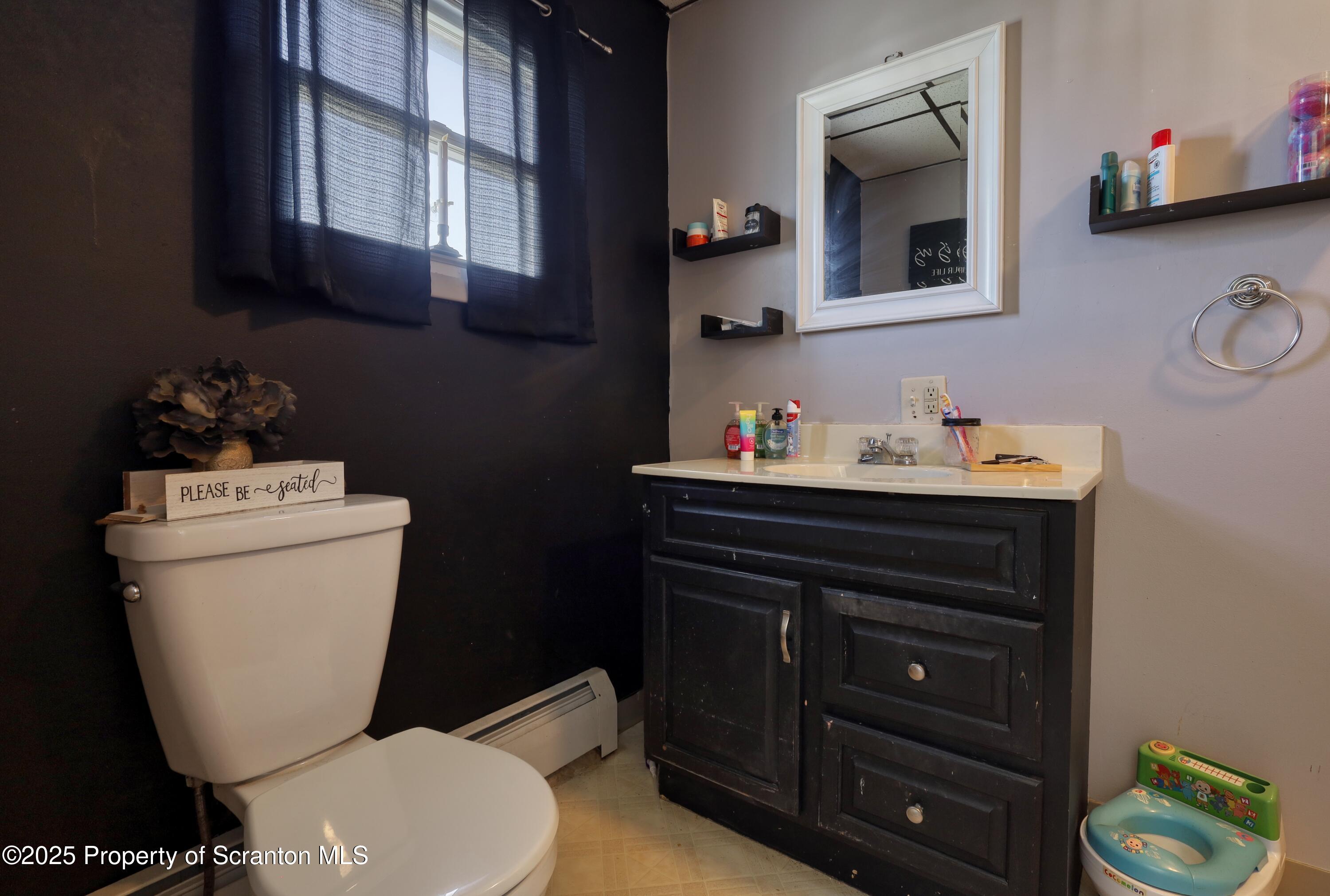 514 Hudson Street Forest City, PA 18421 - Photo 17 of 36 a bathroom with a toilet sink and mirror