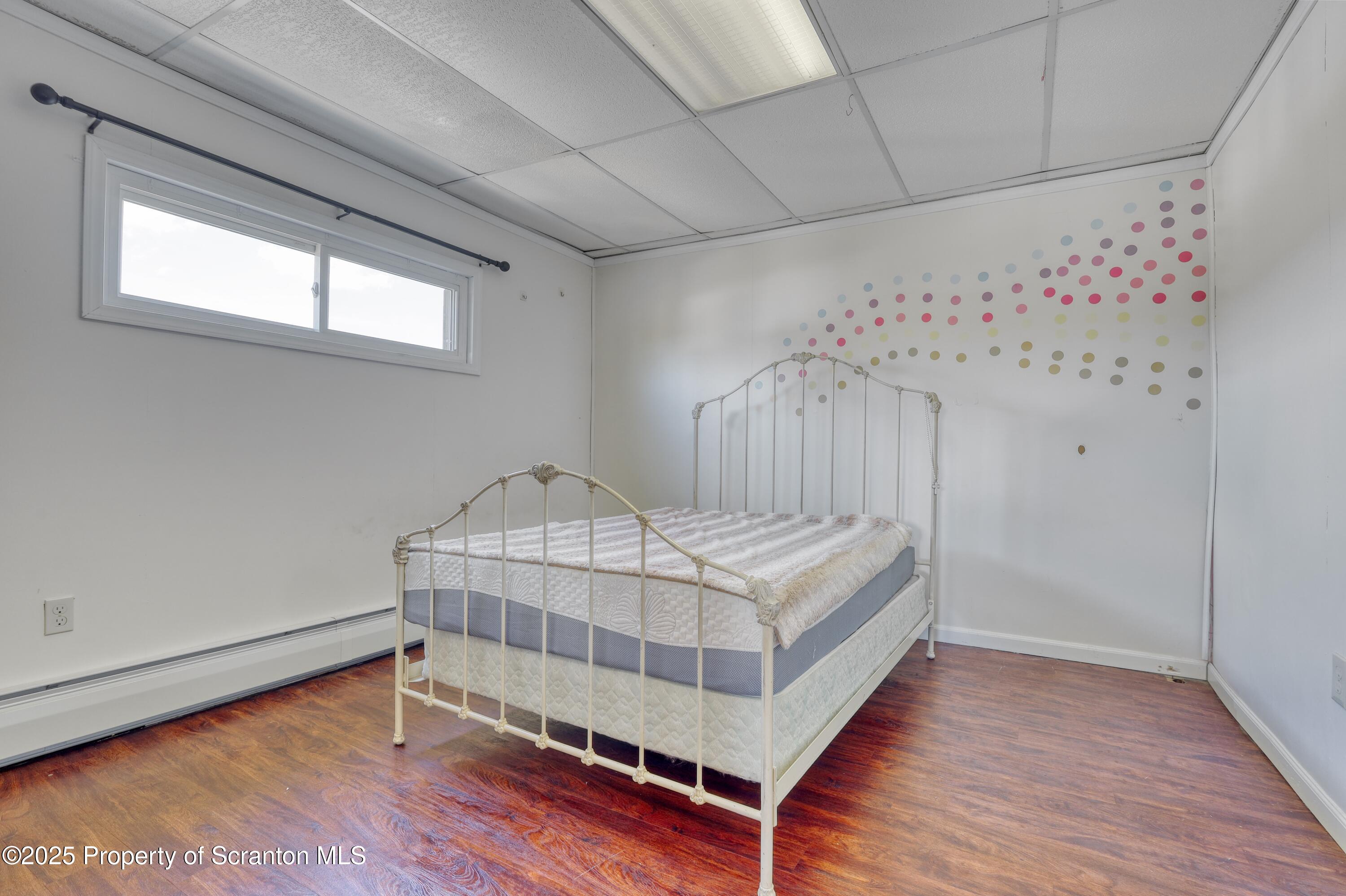 514 Hudson Street Forest City, PA 18421 - Photo 23 of 36 a bedroom with a bed and wooden floor