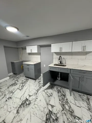 a kitchen with a stove sink and cabinets