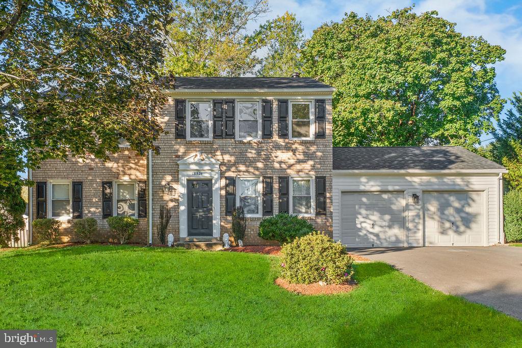 Charming brick home with lush greenery.