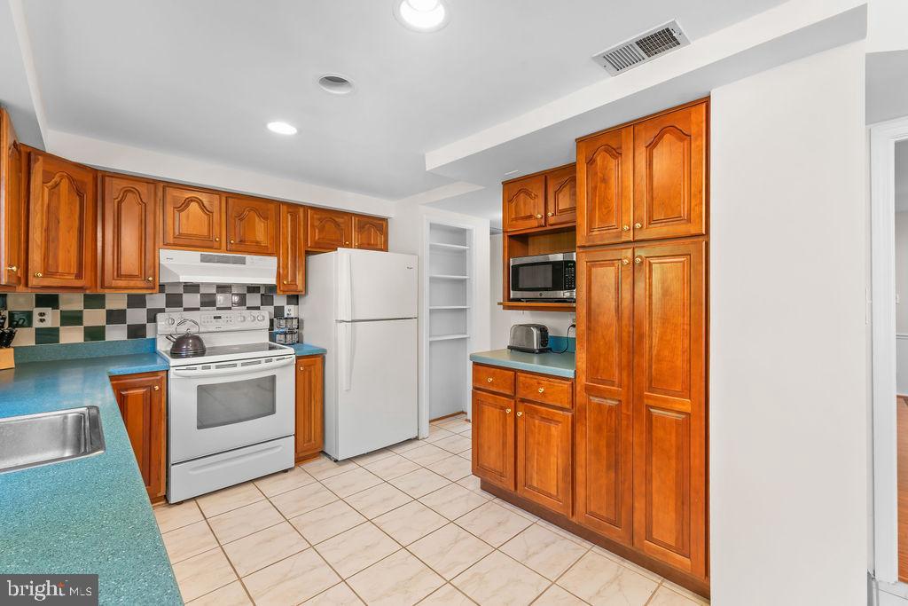 18324 Darnell Drive Olney, MD 20832 - Photo 5 of 25 Charming kitchen with rich wood cabinetry.