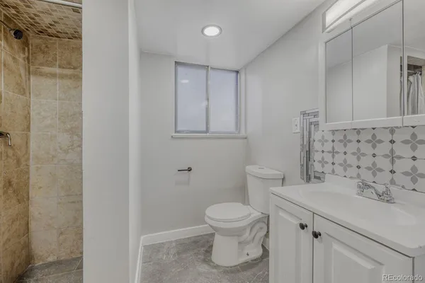 a bathroom with a toilet and a sink