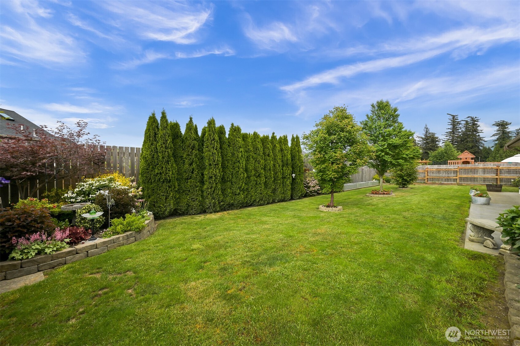 502 Westview Place Nooksack, WA 98276 - Photo 26 of 30 a view of a garden with a building in the background