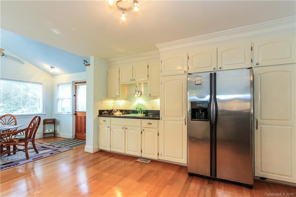 2908 Clover Road Charlotte, NC 28211 - Photo 13 of 27 a kitchen with granite countertop a refrigerator and a stove top oven