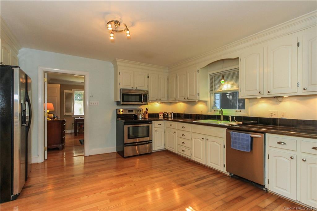 2908 Clover Road Charlotte, NC 28211 - Photo 14 of 27 a kitchen with granite countertop a refrigerator stove top oven and sink