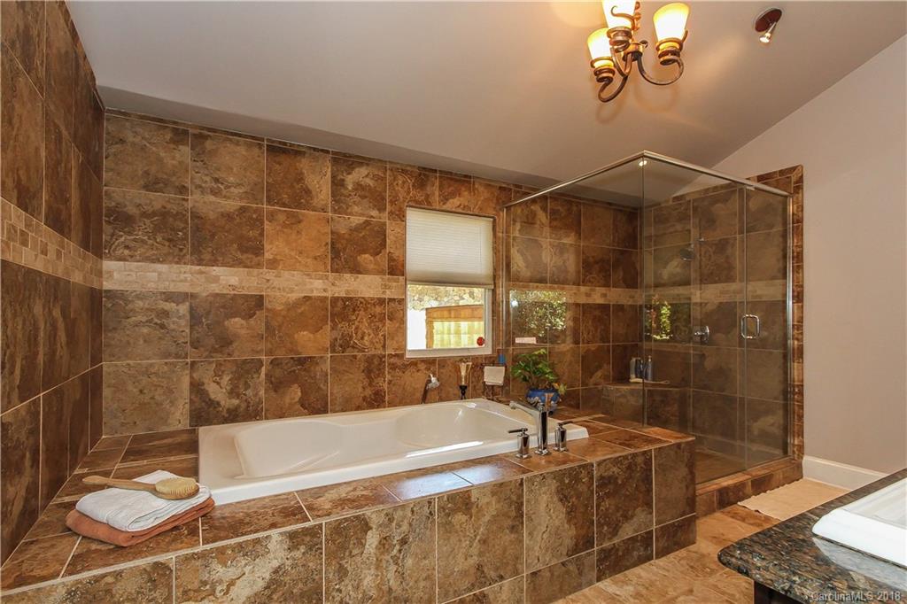 2908 Clover Road Charlotte, NC 28211 - Photo 19 of 27 a bath tub sitting next to a blue shower and a sink