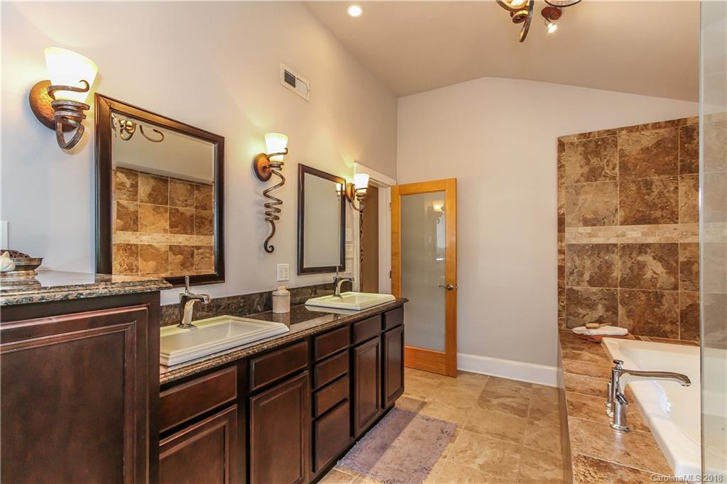 2908 Clover Road Charlotte, NC 28211 - Photo 20 of 27 a bathroom with a double vanity sink a mirror and a shower