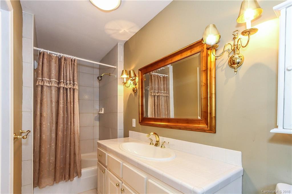 2908 Clover Road Charlotte, NC 28211 - Photo 3 of 27 a bathroom with a sink a mirror and a shower