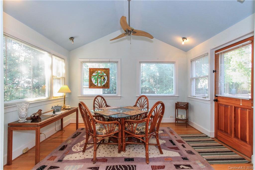 2908 Clover Road Charlotte, NC 28211 - Photo 21 of 27 a dining room with furniture a rug and a large window