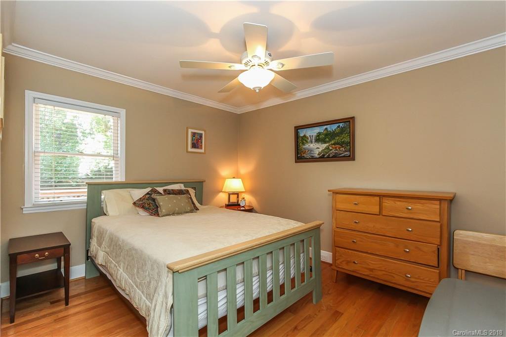2908 Clover Road Charlotte, NC 28211 - Photo 4 of 27 a bedroom with a bed and a baby crib
