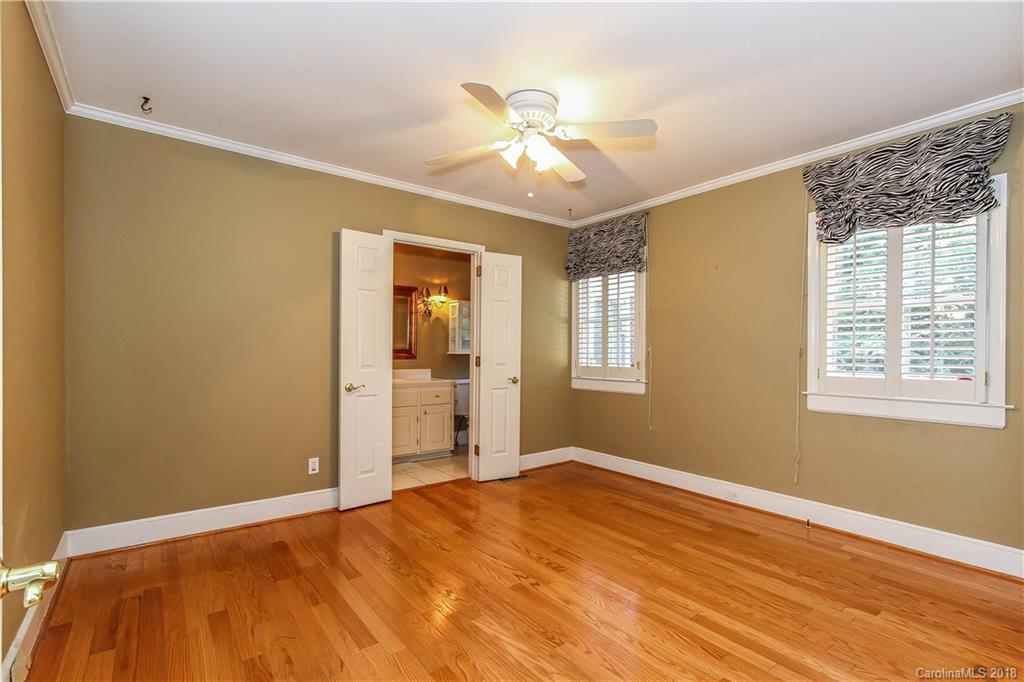 2908 Clover Road Charlotte, NC 28211 - Photo 5 of 27 a view of an empty room with wooden floor and a window