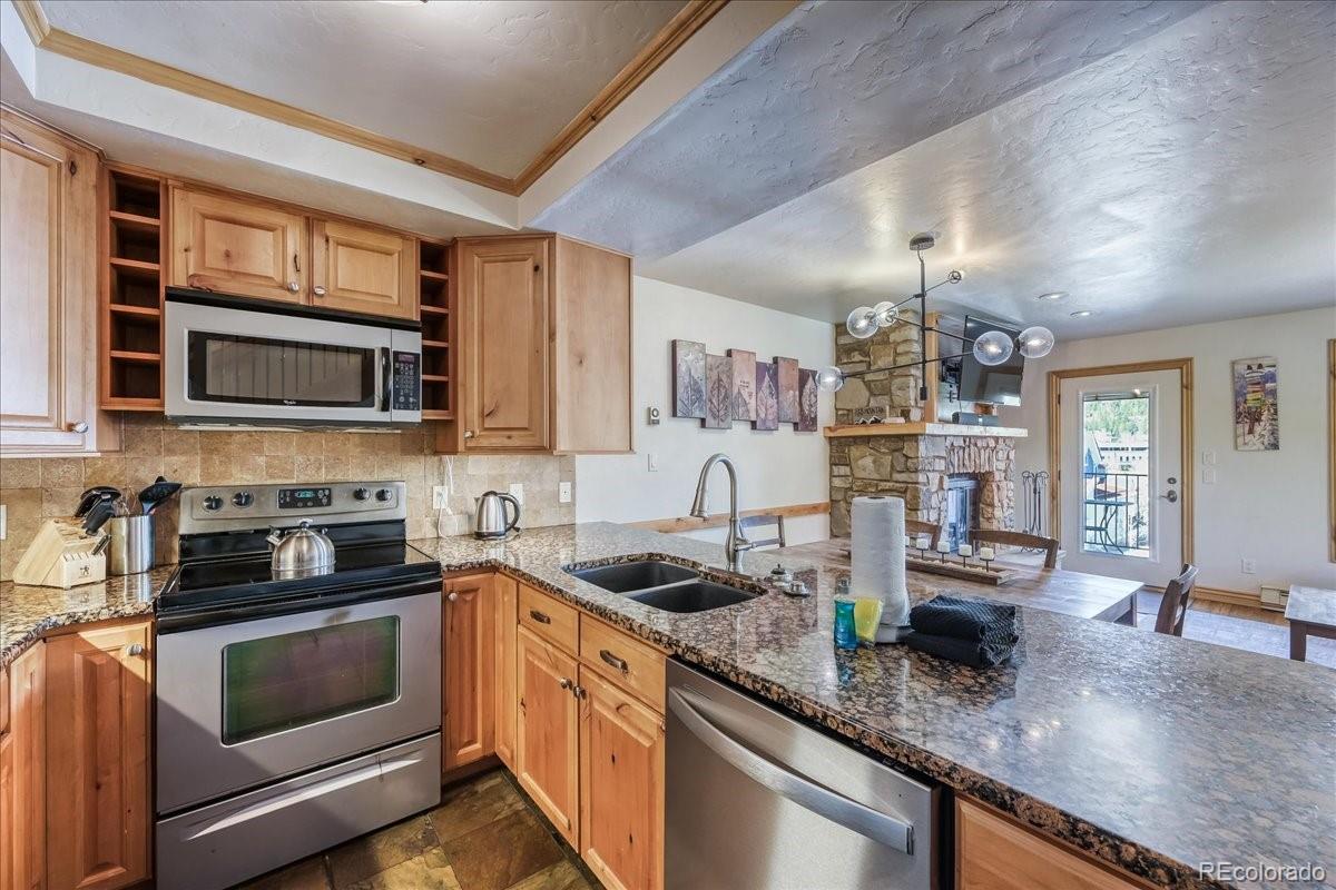 200 North Ridge Street, Unit R1 Breckenridge, CO 80424 - Photo 7 of 27 a kitchen with stainless steel appliances granite countertop a sink stove and microwave