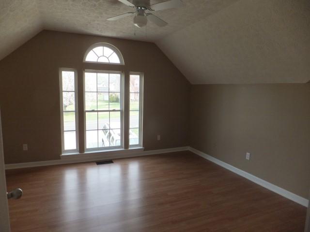3631 Mahlon Moore Road Spring Hill, TN 37174 - Photo 13 of 15 an empty room with wooden floor chandelier and windows