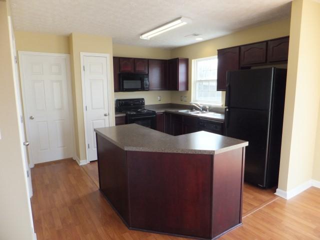 3631 Mahlon Moore Road Spring Hill, TN 37174 - Photo 5 of 15 a kitchen with a refrigerator and a sink