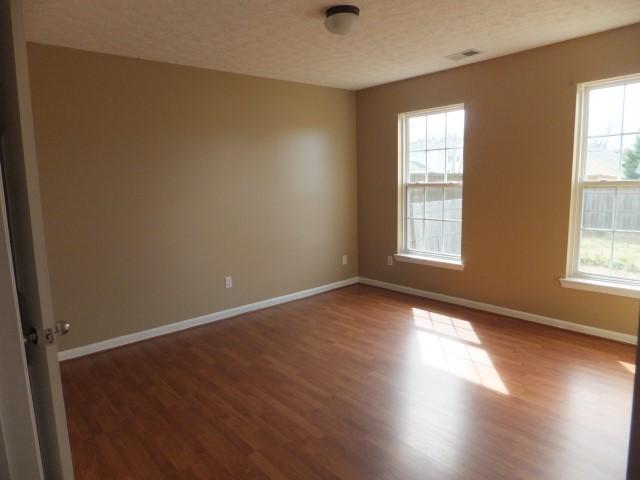3631 Mahlon Moore Road Spring Hill, TN 37174 - Photo 8 of 15 an empty room with wooden floor and windows