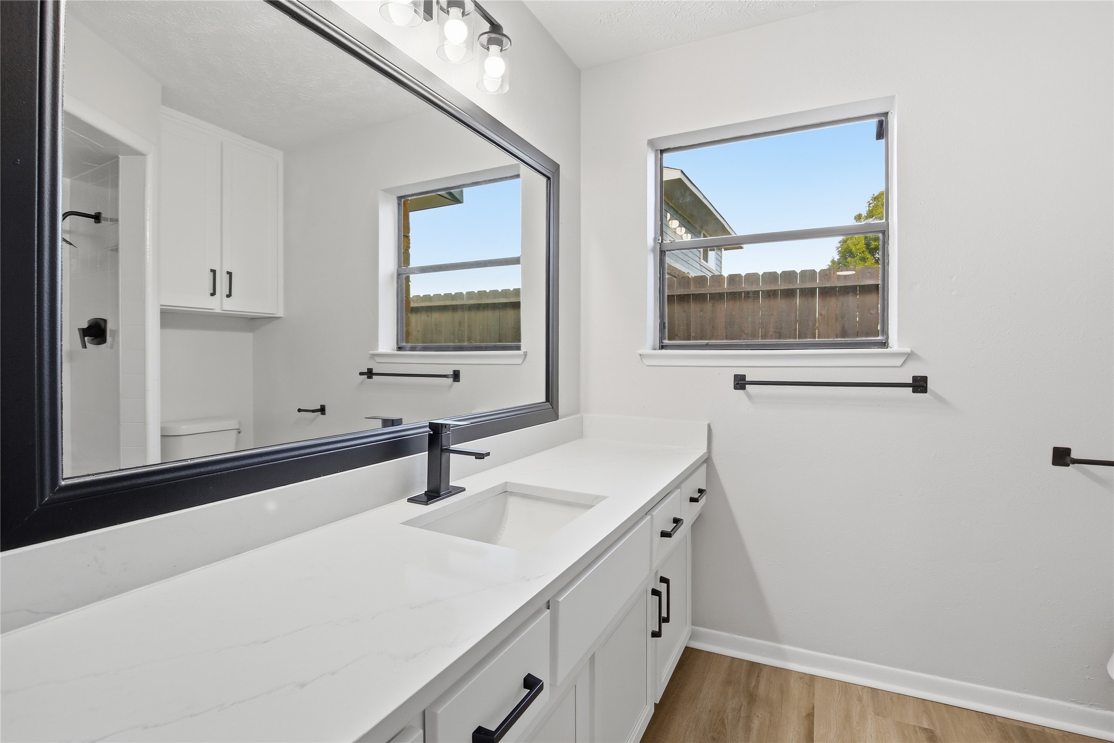 9850 Sageroyal Lane Houston, TX 77089 - Photo 15 of 18 a bathroom with a sink and a mirror