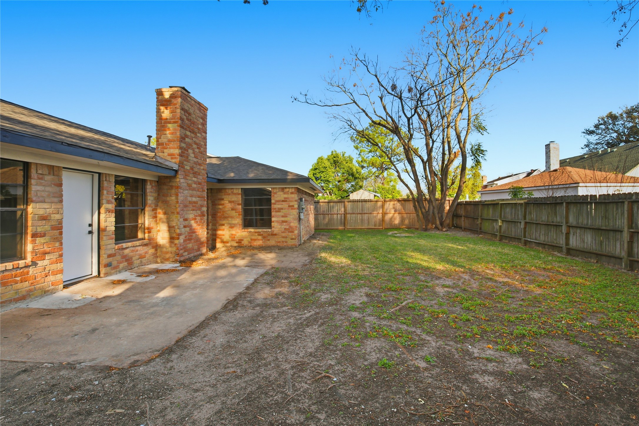 9850 Sageroyal Lane Houston, TX 77089 - Photo 18 of 18 a view of a house with backyard and a tree