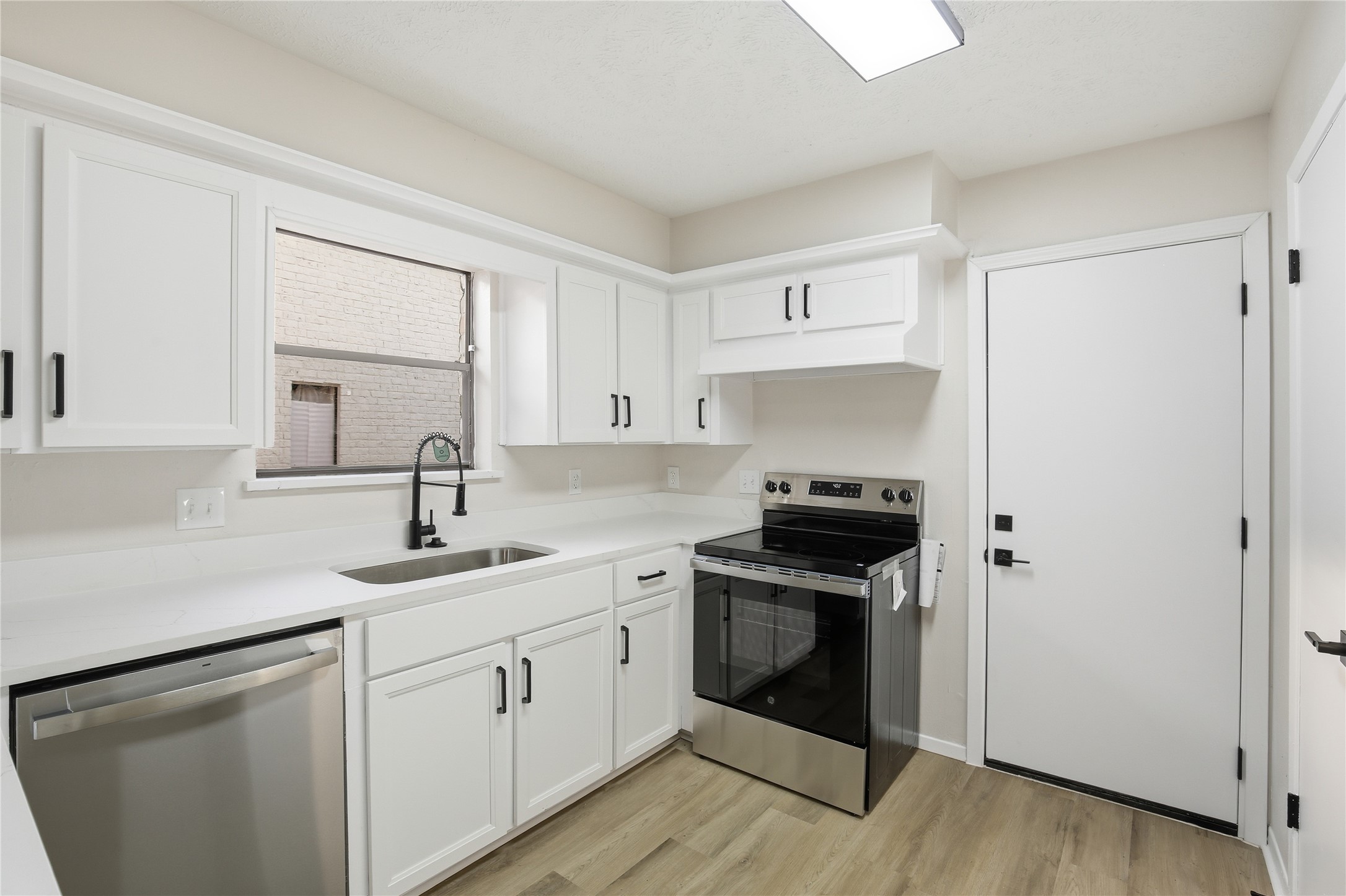 9850 Sageroyal Lane Houston, TX 77089 - Photo 6 of 18 a kitchen with a sink stove and cabinets