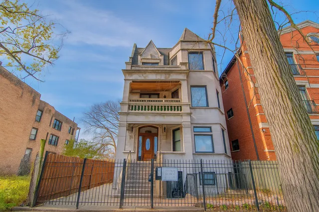 a view of a brick house with large windows