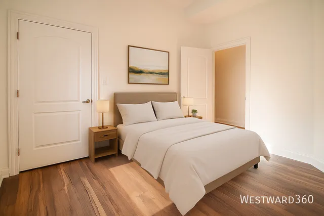 a bedroom with a bed and a painting on the wall