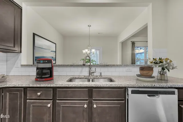 a kitchen with granite countertop a sink and a white stainless steel appliances