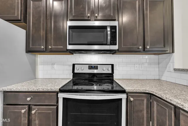 a stove top oven sitting inside of a kitchen