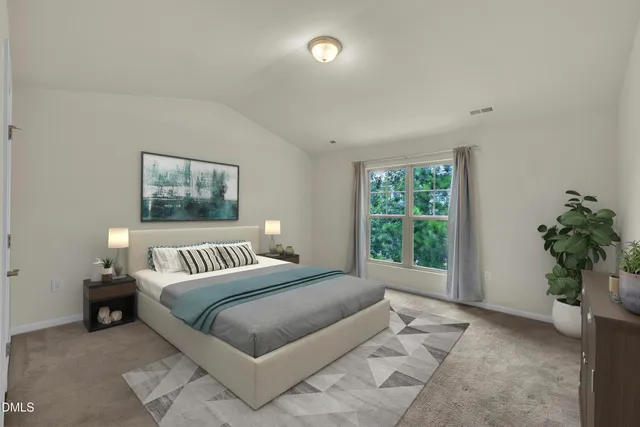 a bedroom with a large bed and a potted plant