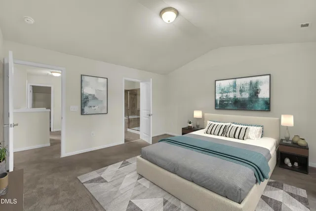 a bedroom with a large bed and painting on the wall