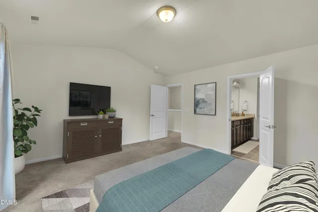 a bedroom with a bed and a television