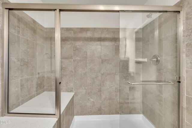 a bathroom with a shower and a bath tub