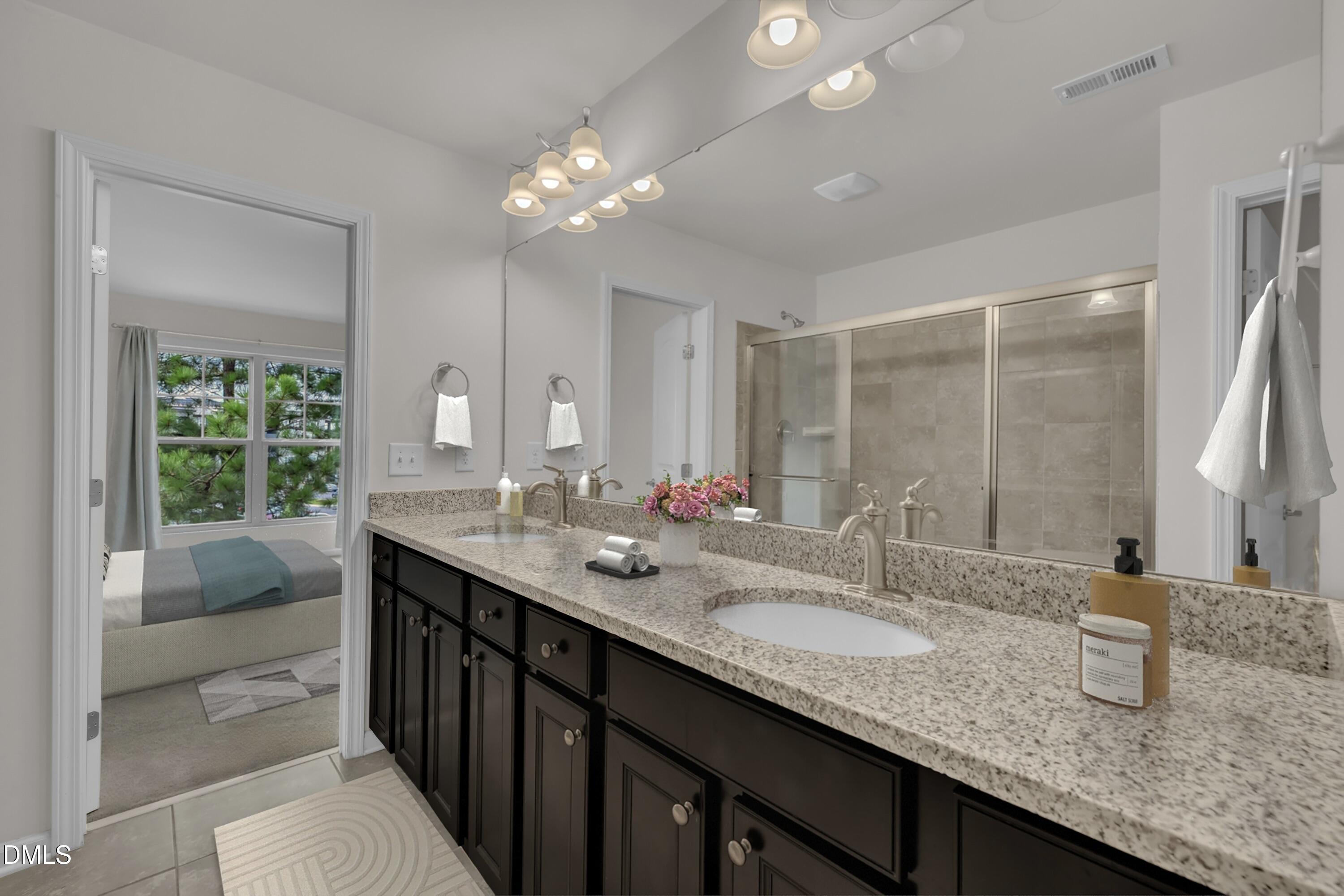 519 Brier Crossings Loop Durham, NC 27703 - Photo 21 of 36 a bathroom with double vanity sinks a vanity a lamp and a mirror