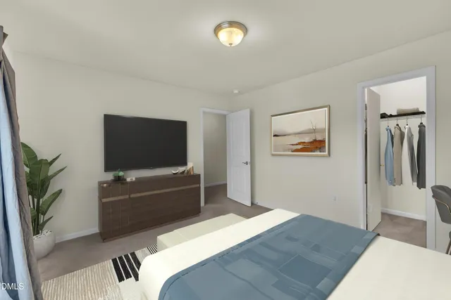 a bedroom with furniture and a flat screen tv