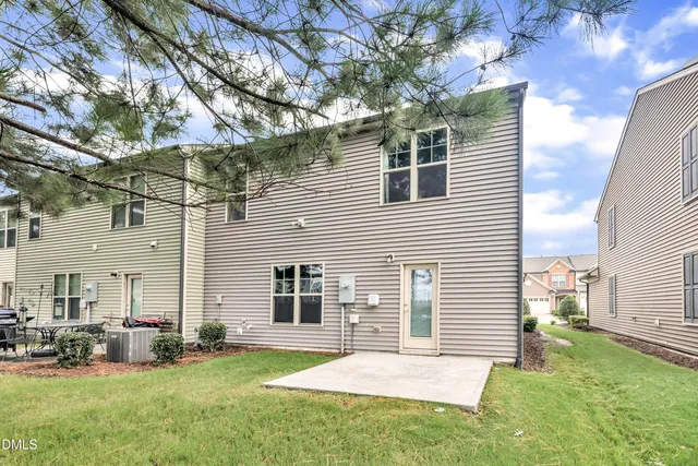a view of a house with a yard and sitting area