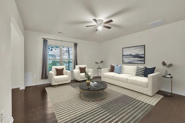 a living room with furniture and wooden floor