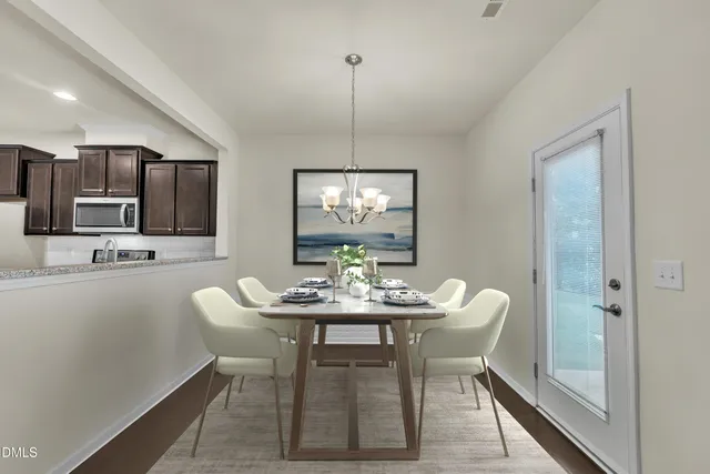 a dining room with furniture a chandelier and window