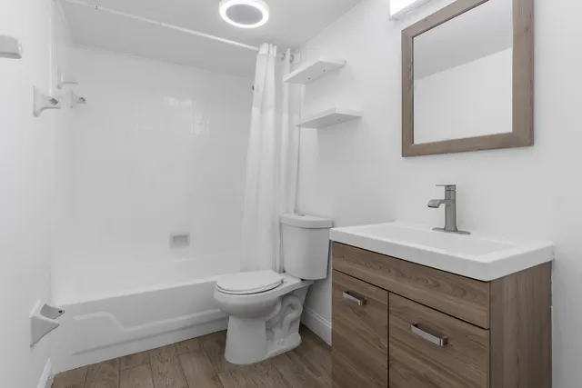 a bathroom with a sink toilet and shower