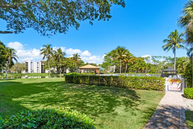 a view of a garden with a building in the background
