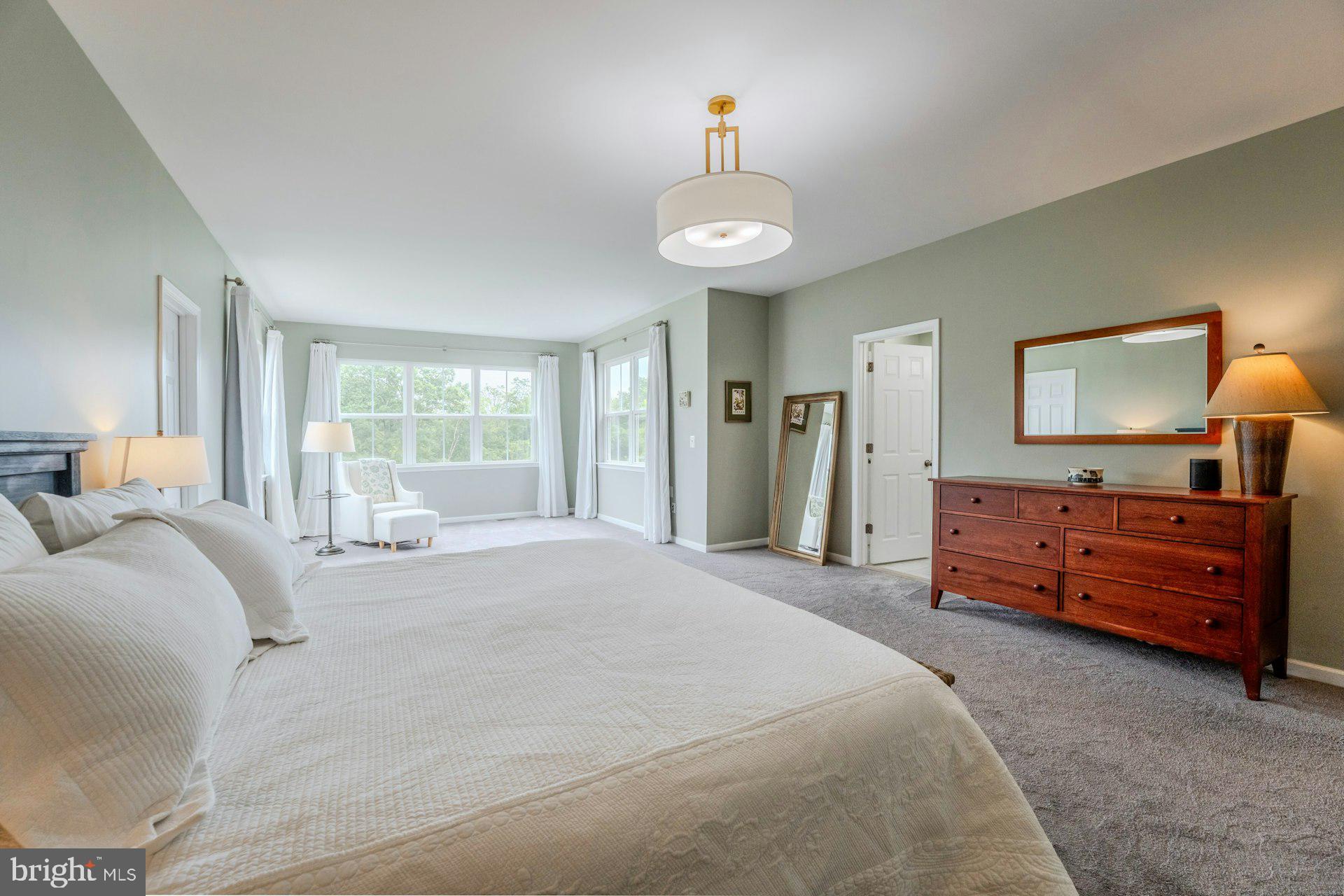18120 Ridgewood Place Round Hill, VA 20141 - Photo 18 of 46 a spacious bedroom with a bed and a large dresser